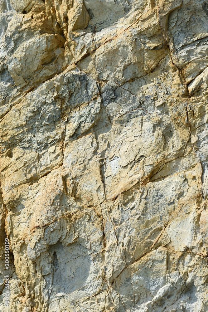 The texture of the surface rocks with an orange color under daytime sunlight