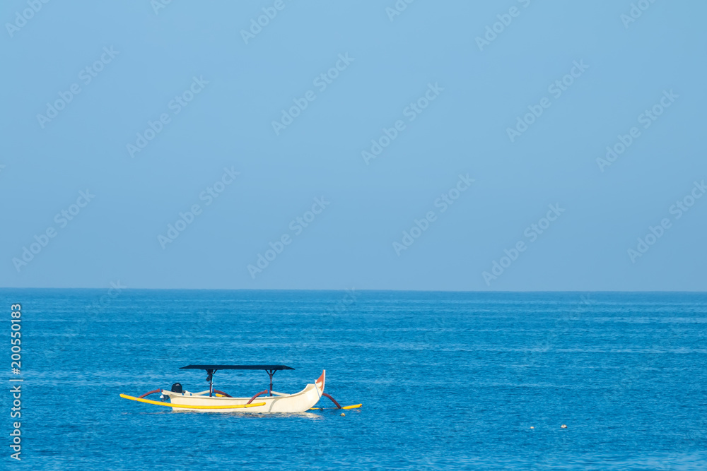 Naklejka premium Traditional bali fishing boat on the sea in Nusa Dua, Bali, Indonesia.