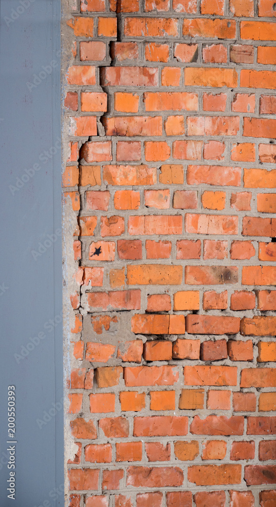 Fototapeta premium A crack in an old brick wall. Background