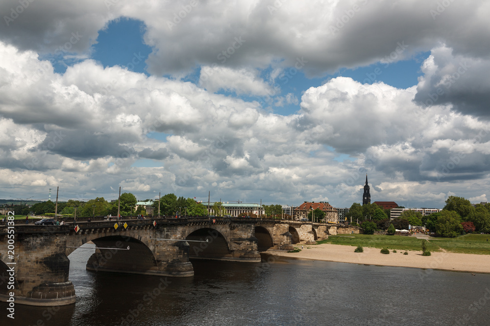 Fototapeta premium stone arch bridge across the Elbe river in Dresden, Germany. A journey through the ancient cities of Europe. Ancient architecture of Germany