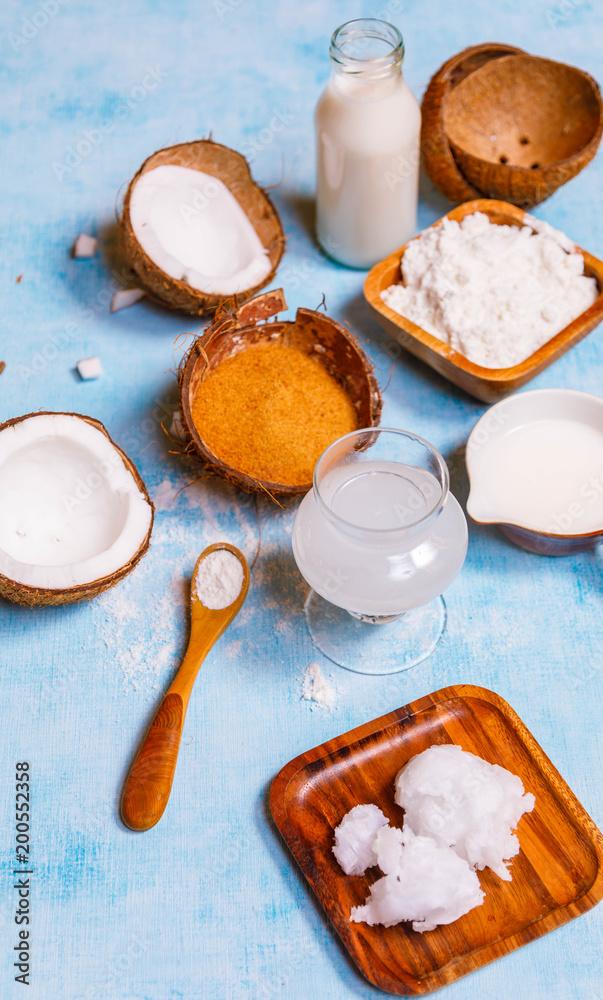 Coconut products, water, milk, cream, sugar, flour, oil is blue background, Top view, healthy eating, dieting, clean eating, vegetarian, vegan, fitness, healthy lifestyle concept, copyspace Coconut products, water, milk, cream, sugar, flour, oil is blue background, Top view, healthy eating, dieting, clean eating, vegetarian, vegan, fitness, healthy lifestyle concept, copyspace