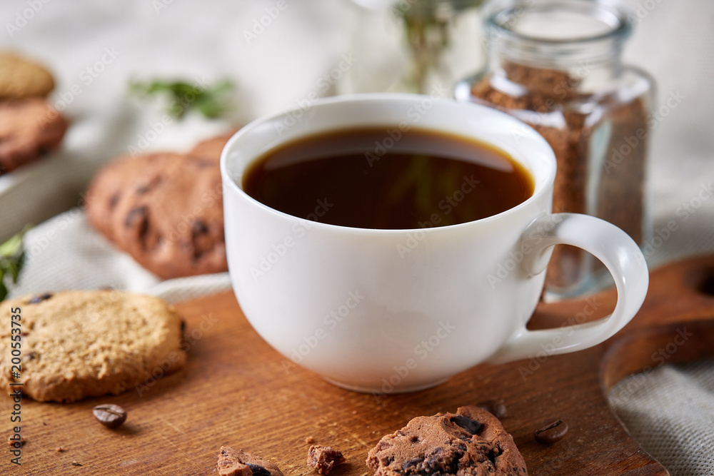 Coffee cup, jar with coffee beans, cookies over rustic background, selective focus, close-up, top view Coffee cup, jar with coffee beans, cookies over rustic background, selective focus, close-up, top view