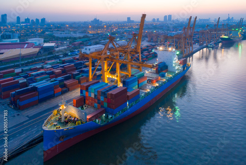 Aerial view of business port with shore crane loading container in container ship in import/export and business logistics with crane and shipping cargo.International transportation concept. © Getty Gallery