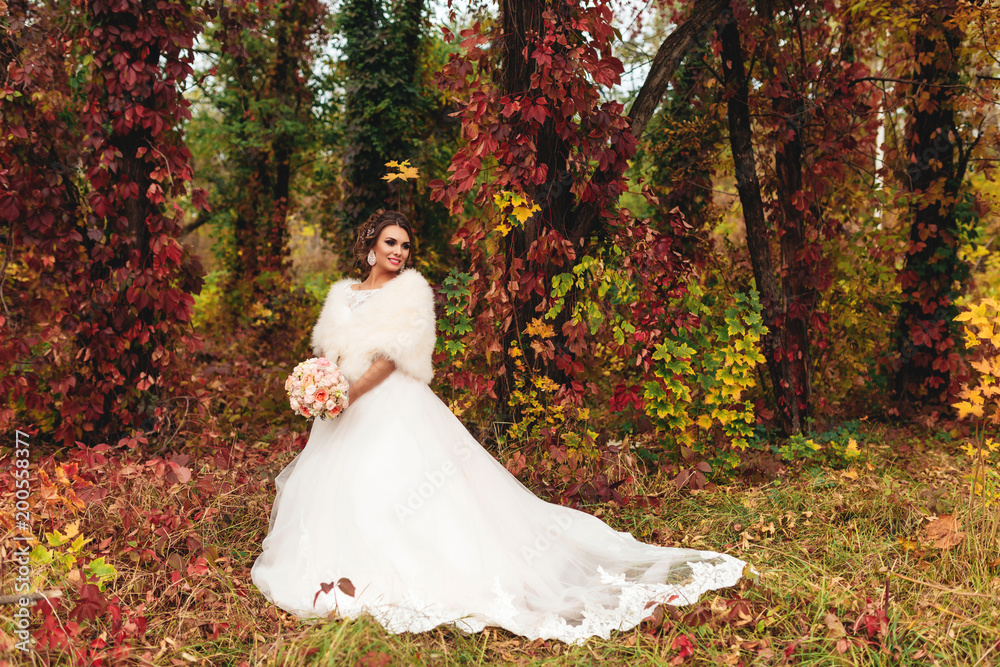 Portrait of a bride with in the mysterious autumn forest