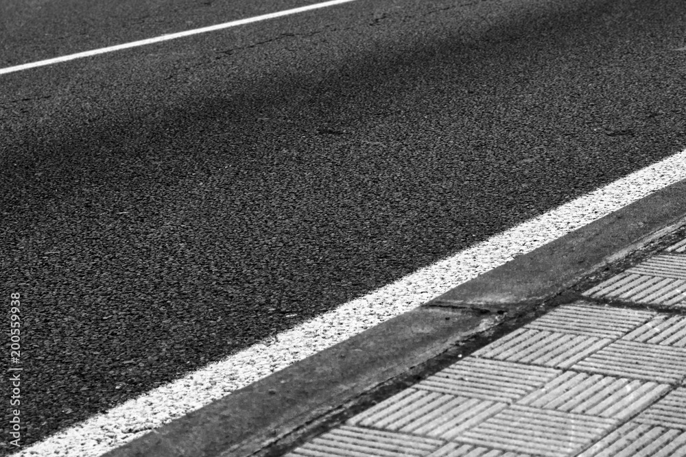 Fototapeta premium Asphalt, sidewalk and diagonal lines