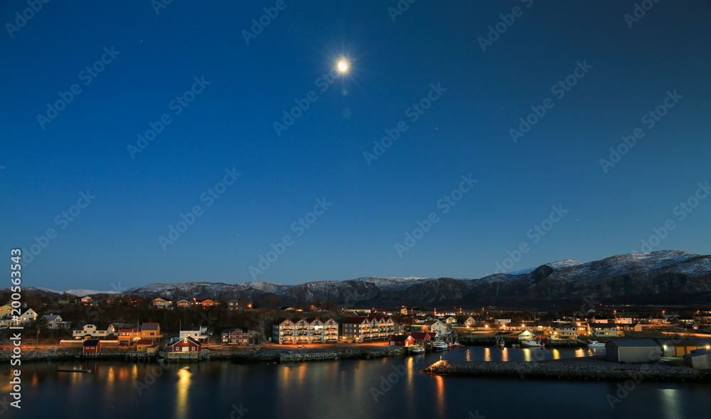 Moon  over the city in Northern Norway