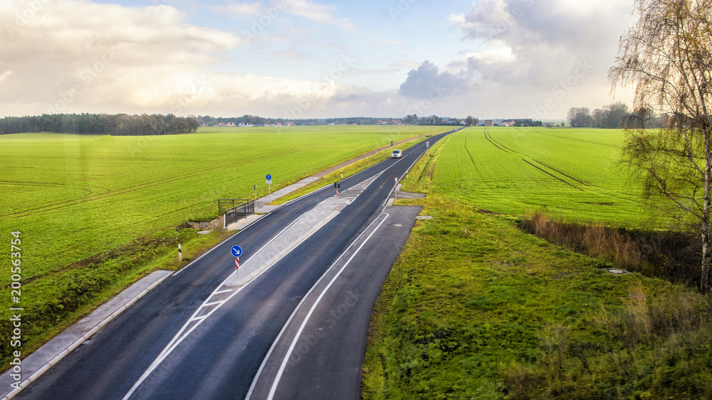 Fototapeta premium Road between countryside views