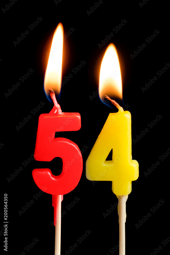 Burning candles in the form of 54 fifty four (numbers, dates) for cake isolated on black background. The concept of celebrating a birthday, anniversary, important date, holiday, table setting Burning candles in the form of 54 fifty four (numbers, dates) for cake isolated on black background. The concept of celebrating a birthday, anniversary, important date, holiday, table setting