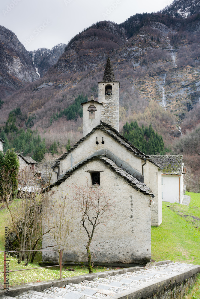 old rustic historic stone church in a remote mountian valley in the Swiss Alps