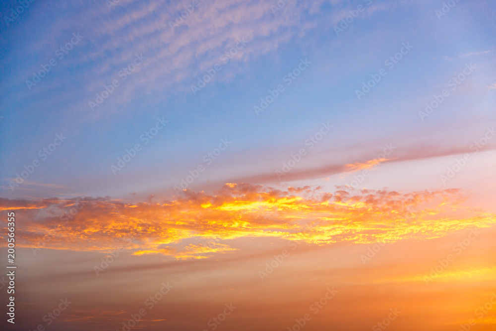 Golden sunset clouds at blue sky Golden sunset clouds at blue sky