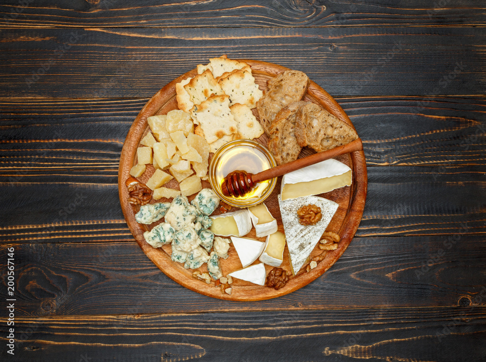 Brie cheese on a wooden Board with bread and sweet honey Brie cheese on a wooden Board with bread and sweet honey