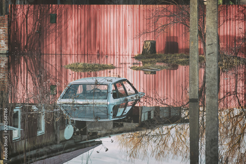 Russia, Balashov April 13, 2018. Flooded during the spring disaster to the roof car before the gates of a private house. High water in river flow freshet flood photo