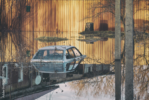 Russia, Balashov April 13, 2018. Flooded during the spring disaster to the roof car before the gates of a private house. High water in river flow freshet flood photo