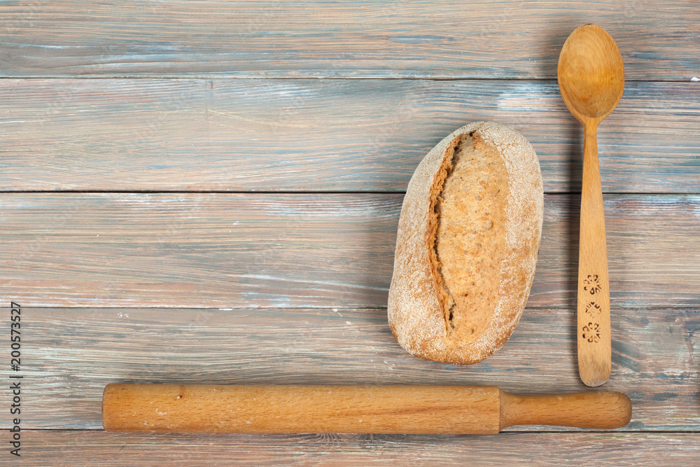 Many mixed breads and rolls of baked bread on wooden table background. Top view Many mixed breads and rolls of baked bread on wooden table background. Top view