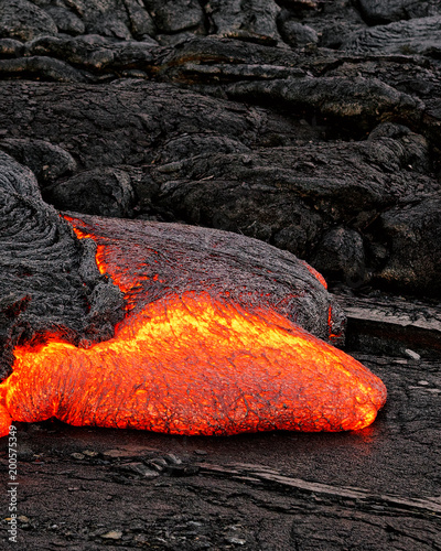 Hot magma escapes from an earth column as part of an active lava flow, the glowing lava slowly cools and freezes - Location: Hawaii, Big Island, volcano "Kilauea"