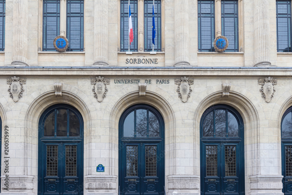 Facade of Sorbonne University with France and European Union flags, Paris, France.