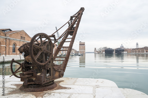 Old rusty crane on an arsenal quay in Venice