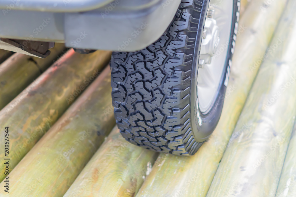 close up of off road tyre on wooden brige