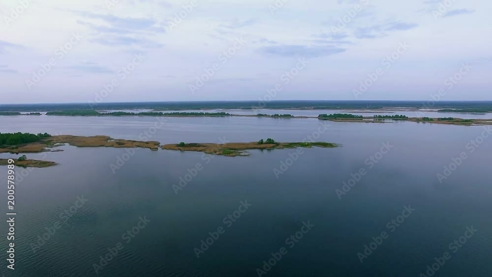 The islands of the Dnieper River in the quiet evening cloudy, aerial View on the islands of the River, flight over the island on the Dnieper River, Ukraine aerial view of islands of the River The islands of the Dnieper River in the quiet evening cloudy, aerial View on the islands of the River, flight over the island on the Dnieper River, Ukraine aerial view of islands of the River