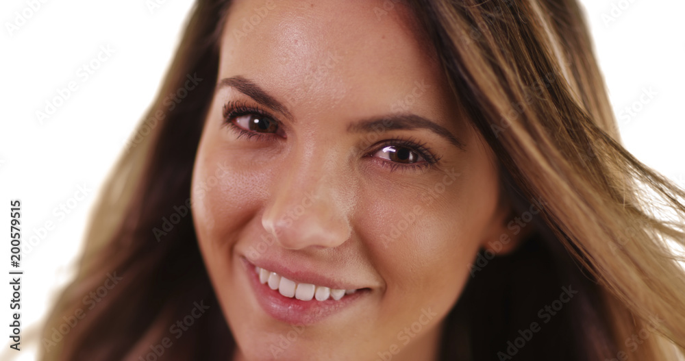 Close-up of pretty millennial girl smiling at camera on white background with copyspace Close-up of pretty millennial girl smiling at camera on white background with copyspace
