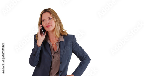 Middle aged adult Caucasian business woman talking on smartphone