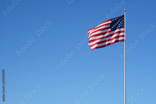 The American flag floats in the air proudly.                              