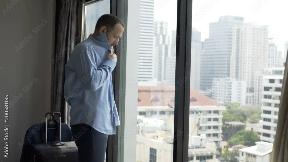 Businessman standing in his apartment and getting ready to work
Businessman standing in his apartment and getting ready to work