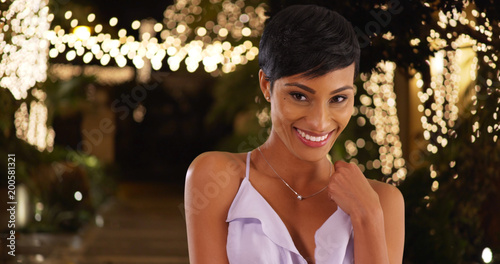 Photography Gorgeous young black woman in lilac dress smiling at camera on summer night