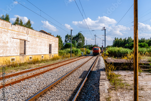 Train passing platform. A Diesel train seen speeding past a platform.