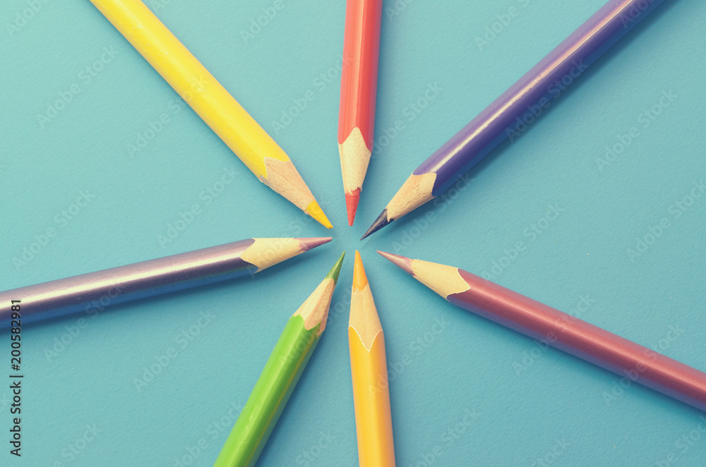 Naklejka premium Colorful ground pencils group on a blue background.