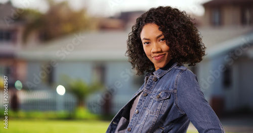 Fotografija Spunky African-American woman posing happily in suburban neighborhood