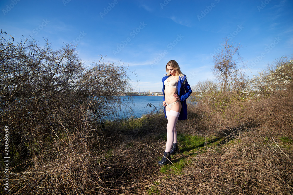 Hot sexy blonde in white lingerie and stockings walking outdoors Hot sexy blonde in white lingerie and stockings walking outdoors
