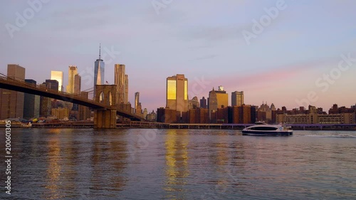 Wallpaper Mural Sunrise over the East River next to the Brooklyn Bridge as a boat floats by with the New York Skyline. Torontodigital.ca