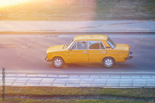 Old Soviet car in sunset rays photo