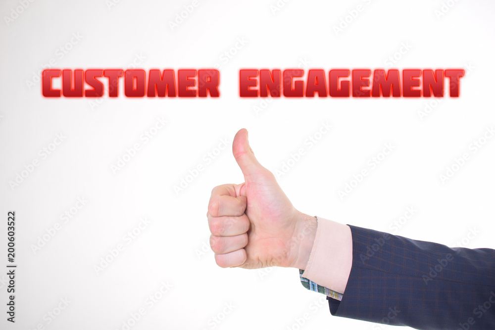 A businessman shows an inscription:CUSTOMER ENGAGEMENT A businessman shows an inscription:CUSTOMER ENGAGEMENT