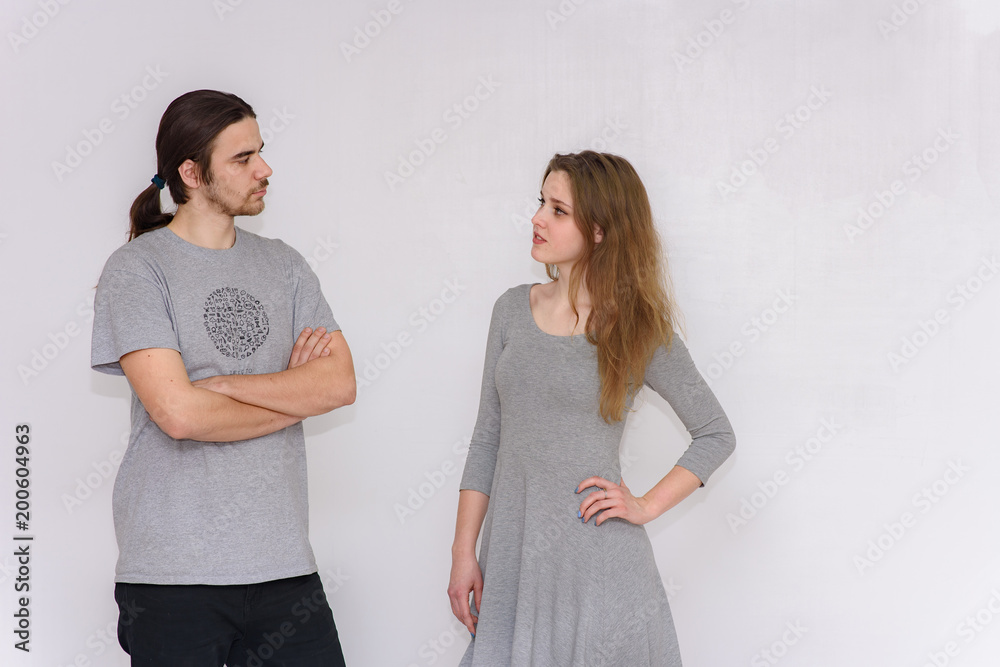 young and beautiful man and woman are standing on white background in different poses young and beautiful man and woman are standing on white background in different poses