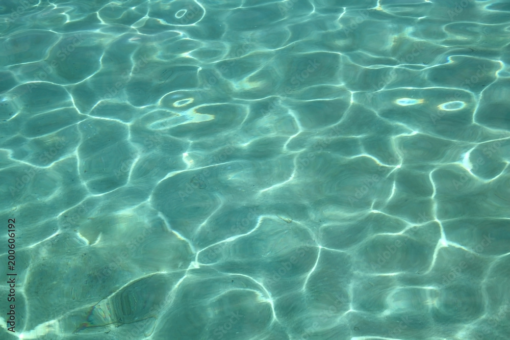 Tropical truquoise blue water with the light reflecting over the sand on the ocean floor, Caribbean.