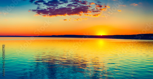 Sunset over the lake. Amazing panorama landscape