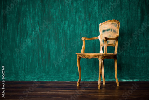 old chair on a green wall background. photo
