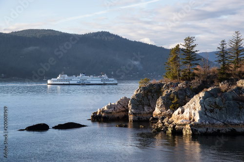 West Vancouver, British Columbia, Canada - March 06 2018: BC Ferries passing by Whytecliff Park during a vibrant sunset.