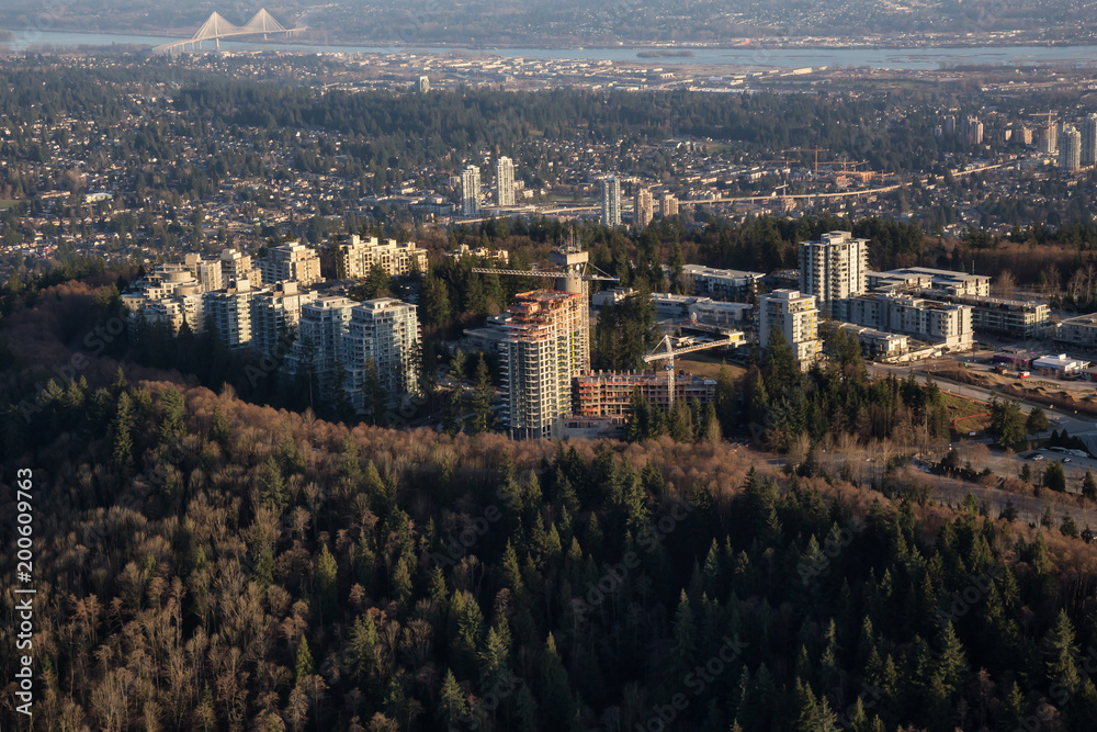 Aerial view of a residential neighborhood on top of Burnaby Mountain during a vibrant sunny day. Taken in Vancouver, British Columbia, Canada.