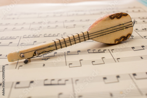Model of Turkish musical instrument saz  on musical notes