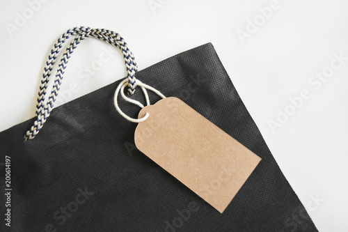 Blank label made of brown paper Strap on black shopping bag.