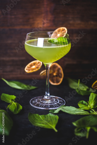 Cocktail on the background of falling lemon slices.