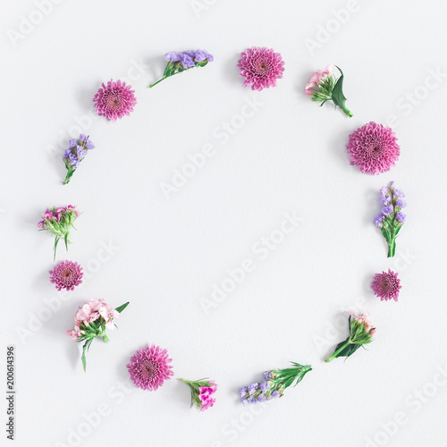 Flowers composition. Wreath made of colorful flowers on gray background. Flat lay, top view, square, copy space