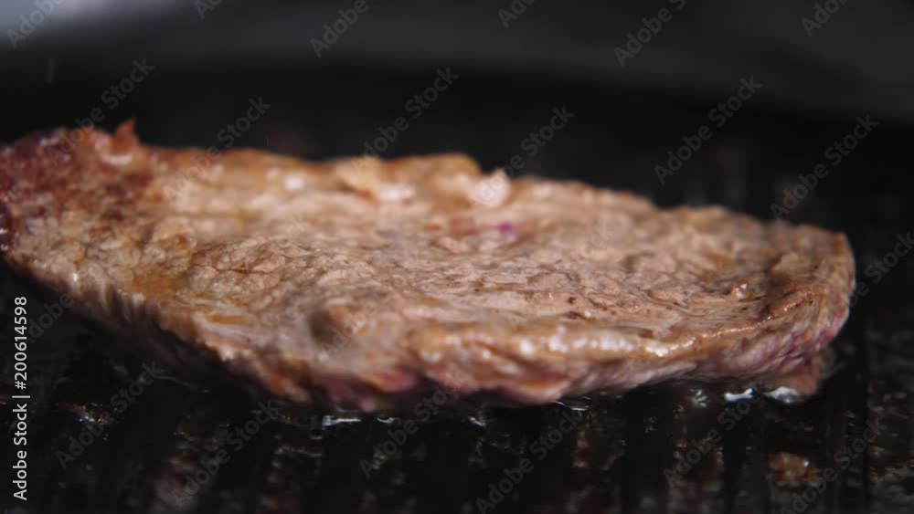 Cooking a juicy slice of steak. Cooking a juicy slice of steak.