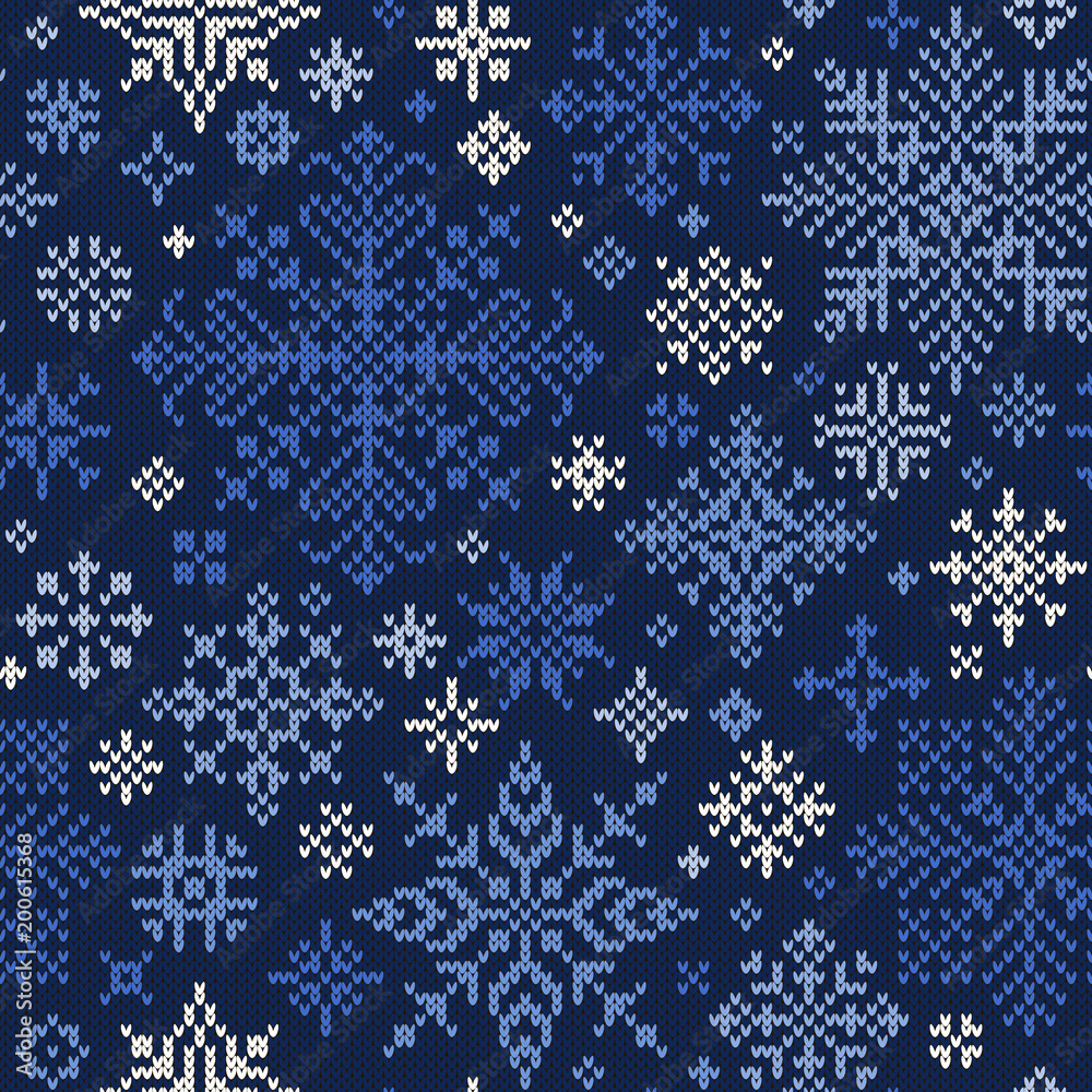 Seamless knitted pattern of blue and white snowflakes