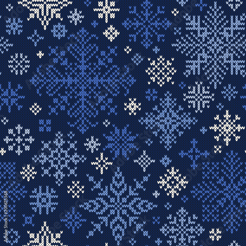 Seamless knitted pattern of blue and white snowflakes