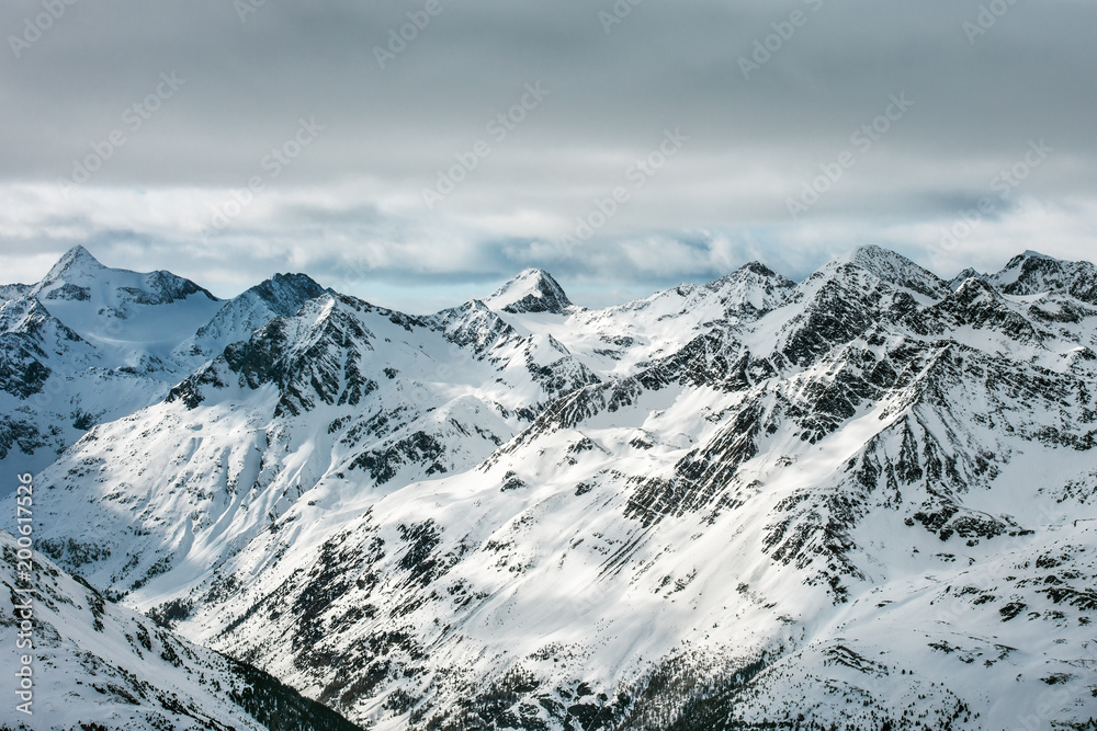 High Alpine landscape. Snow-capped mountain peaks and beautiful tops.