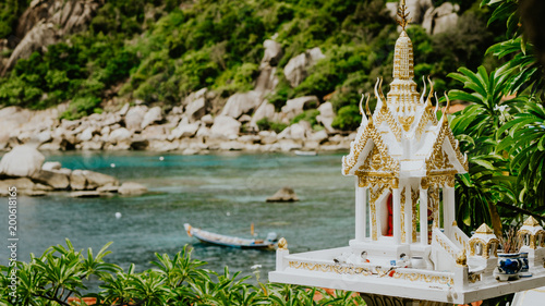 Photography Buddhist spirit house shrine stands on Tanote Bay with Beautiffull Coral Reef, K